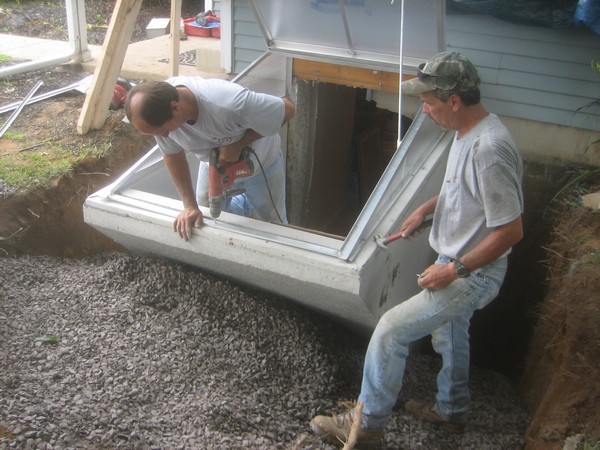 Men working on Installation of Cleargress Door Basement Entrance