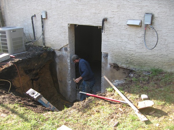 Man working on basement entrace