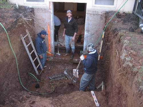 Working men installing egress for basement