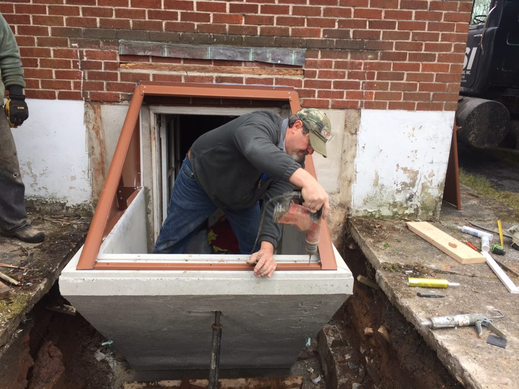 A worker works at installing the Bilco® Door