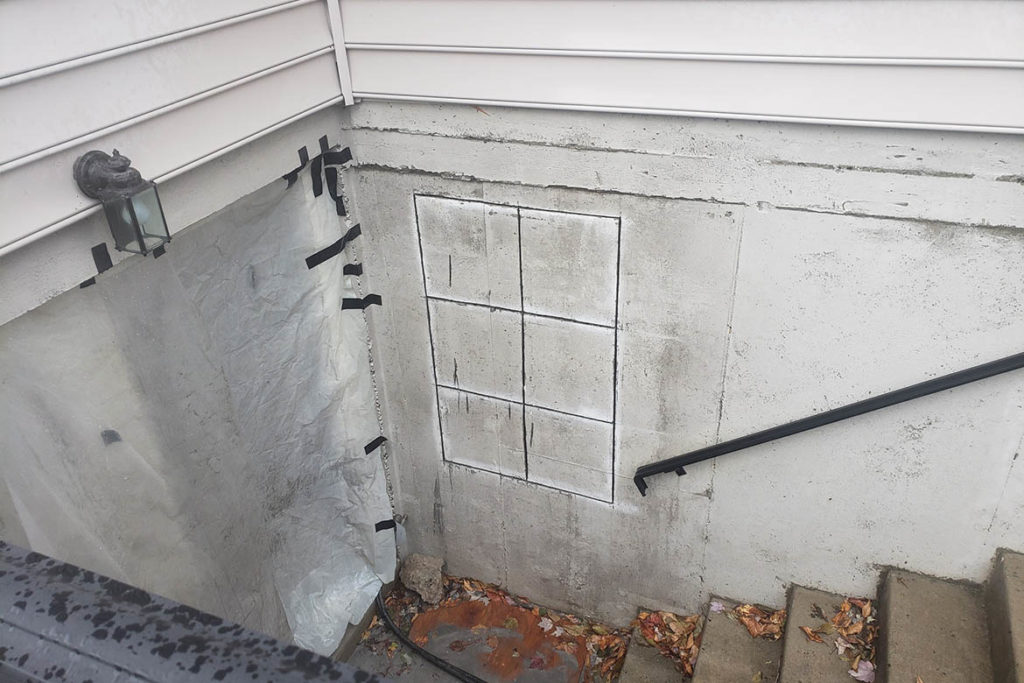 Before installation of a 29″ x 48″, egress compliant, casement window in an existing basement walk out in PAGE LANE, PHOENIXVILLE