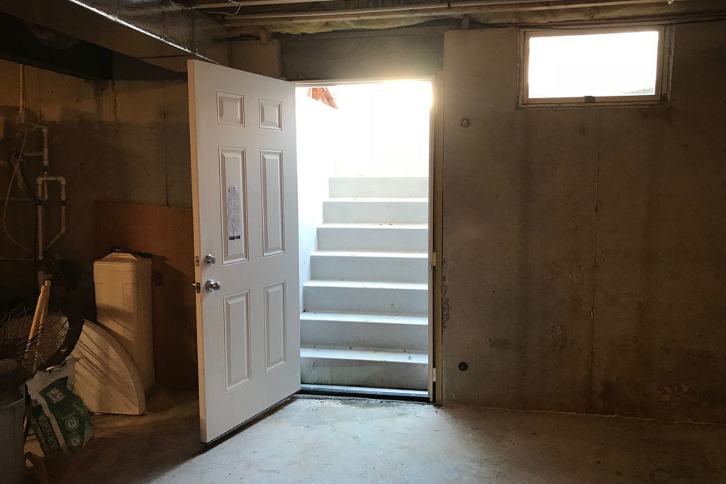 In process to install a Permentry precast concrete stair, with a Bilco door, and a 3/0 x 6/8 insulated six panel door at the base of the stair in KELLER WAY, DOWNINGTOWN